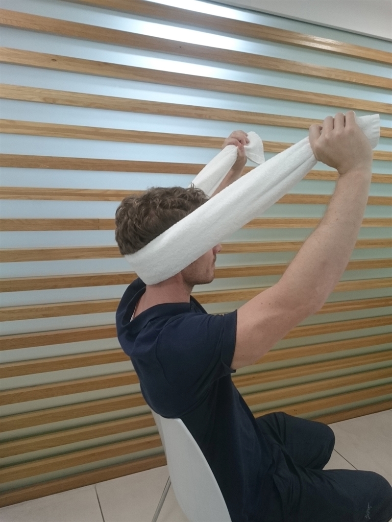 If pain arises from below C2 then a different form of SNAG can be used. In this case the facet plane is towards the patient’s eyes (45°). The towel edge can be used if a strap is not accessible. Sustain for 20seconds, repeat 6 times.