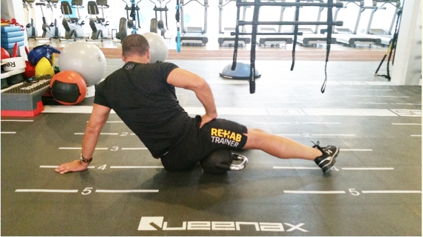 -Lie sideways on a foam roller, trigger ball or in this example, a Kettle Bell. -Position the limb so the posteromedial part of the thigh is on top of the trigger device. -Slowly roll up and down, and forwards and backwards. -This is an ideal way to address tightness in the ischiocondylar part of the AM.